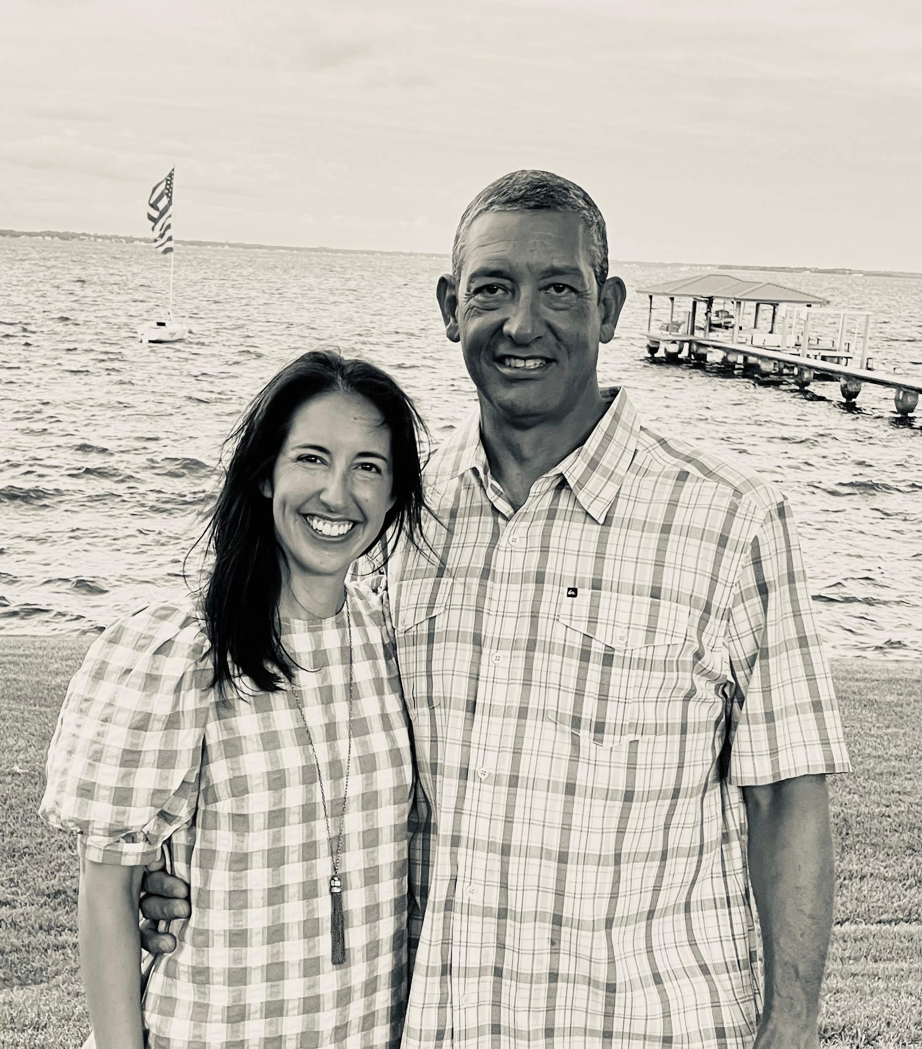Smiling couple standing together by the waterfront