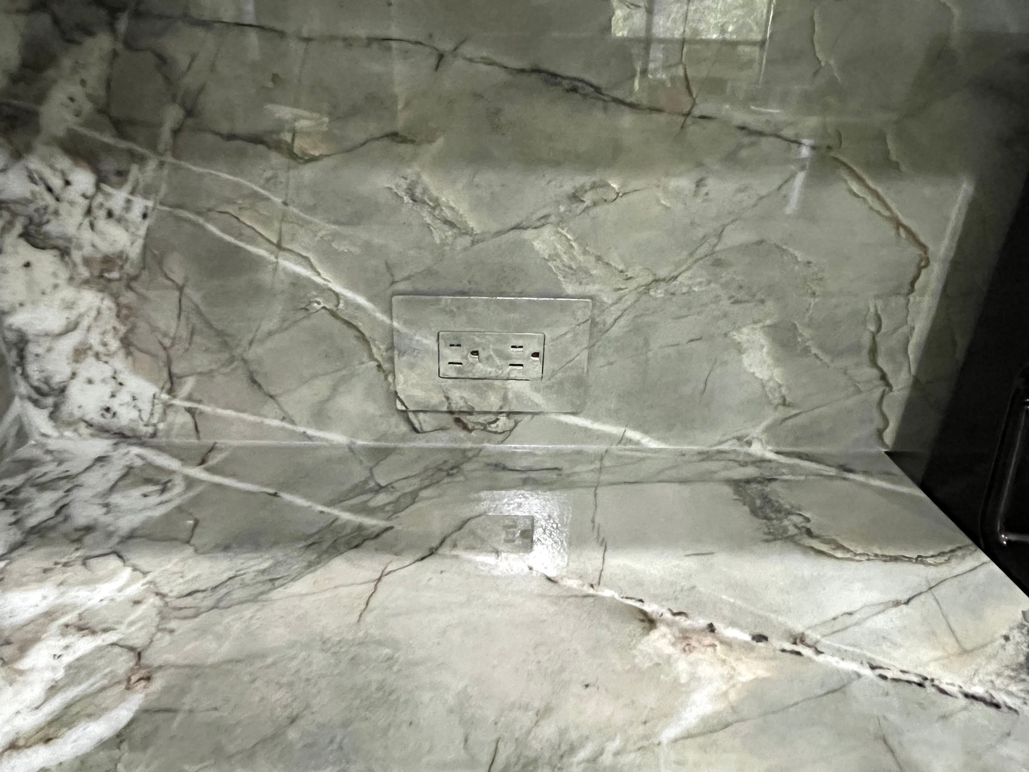 Gray veined stone-look countertop and backsplash finish